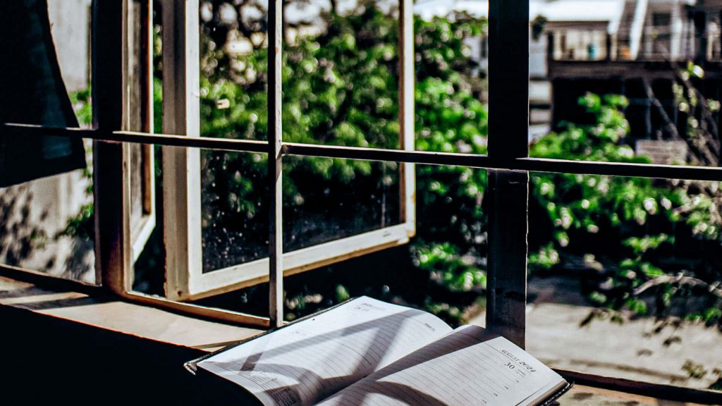 Journal at the window overlooking garden - How to Create Your Own Spiritual Retreat