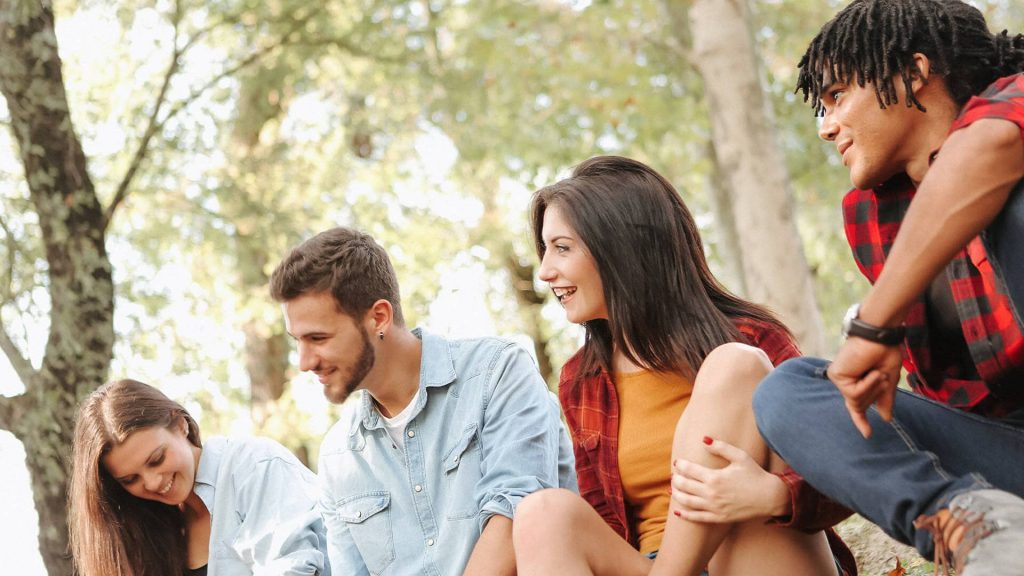 Four friends hanging out in a forest - End of serial monogamy, embrace platonic friendships