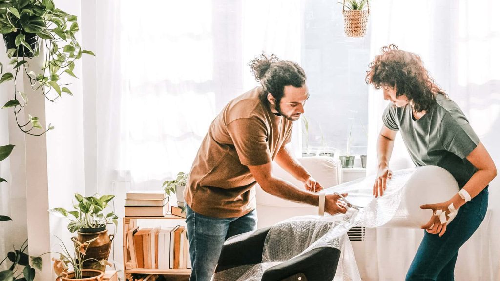 Couple organizing their living room - thrive in a relationship with an organized person