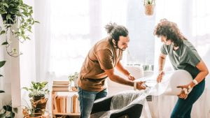 Couple organizing their living room - thrive in a relationship with an organized person