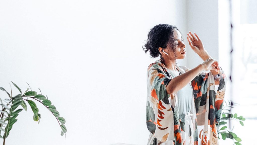 Woman standing with eyes closed in one-minute meditation - How to make daily meditation work for any schedule