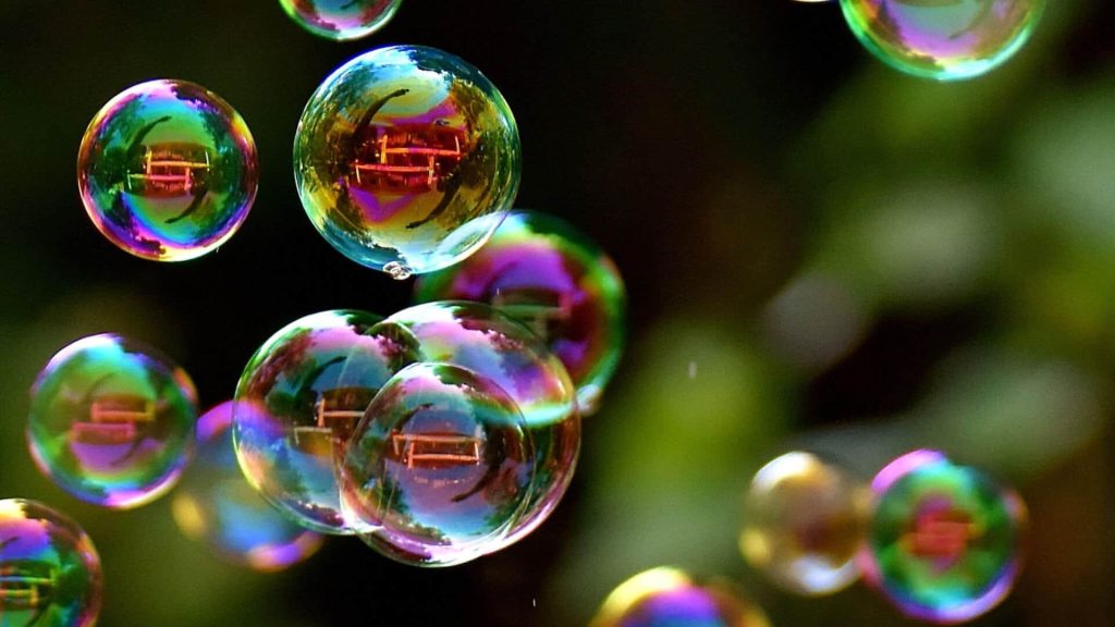 Soap bubbles in the sun, floating above the past